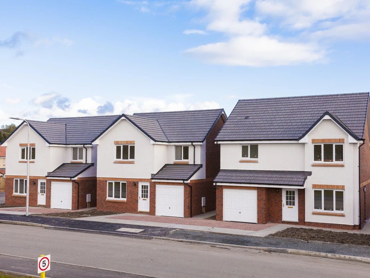 Row of new detached houses with exterior painting by Hull Decorators, consistent front elevation finish