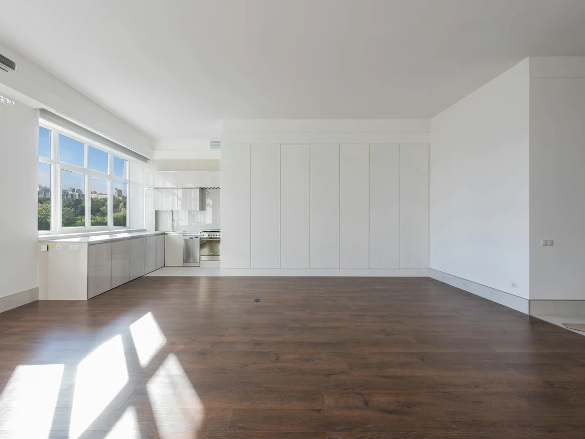 Large empty room with fresh white interior painting completed by Hull Decorators