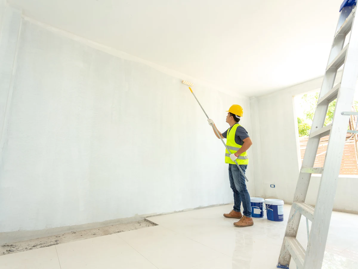 painting-decorating-painter-hivis-rolling-hull-decorators Painter and decorator in Longhill and Bilton Grange by Hull Decorators, rolling paint in hi-vis jacket